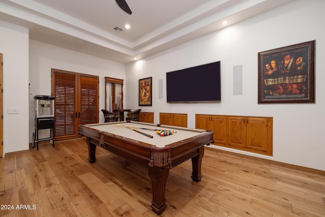 rec room featuring a raised ceiling, light wood-type flooring, and billiards