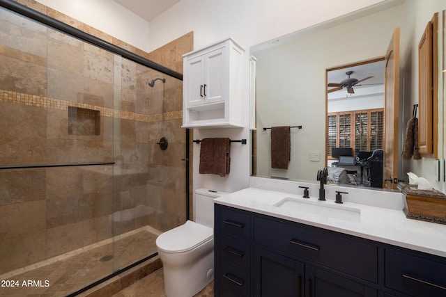 bathroom featuring an enclosed shower, vanity, toilet, and ceiling fan