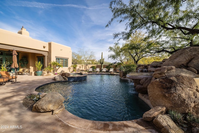 view of swimming pool featuring an in ground hot tub and a patio