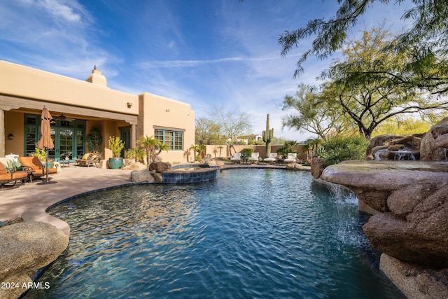 view of pool featuring a patio area, an in ground hot tub, ceiling fan, and pool water feature