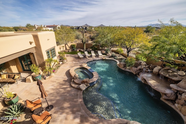 view of pool featuring an in ground hot tub and a patio