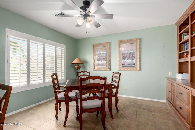 dining area with a ceiling fan and baseboards