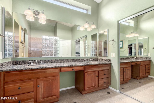 bathroom with tile patterned floors, a sink, and double vanity