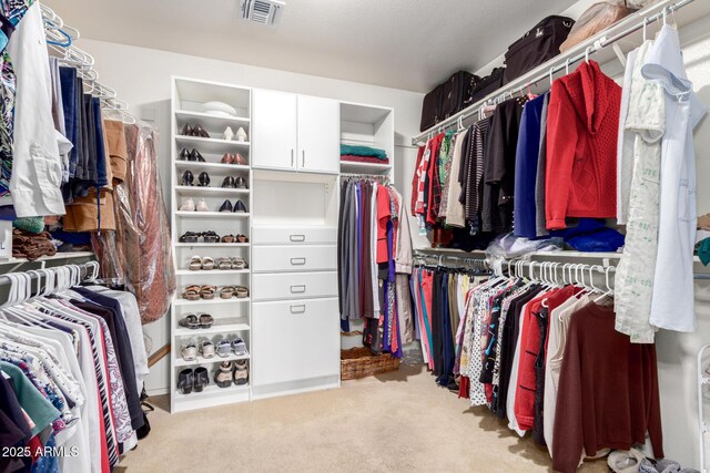 walk in closet with carpet flooring and visible vents