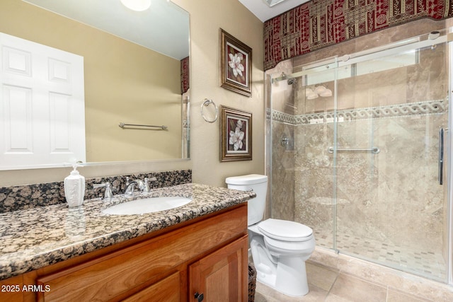 full bath featuring a stall shower, vanity, toilet, and tile patterned floors