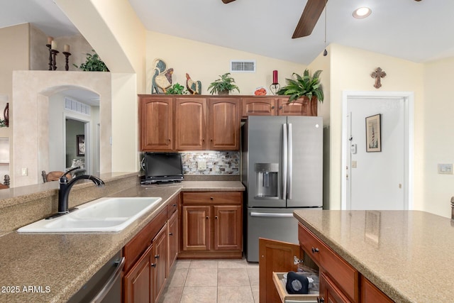 kitchen featuring visible vents, ceiling fan, vaulted ceiling, stainless steel appliances, and a sink