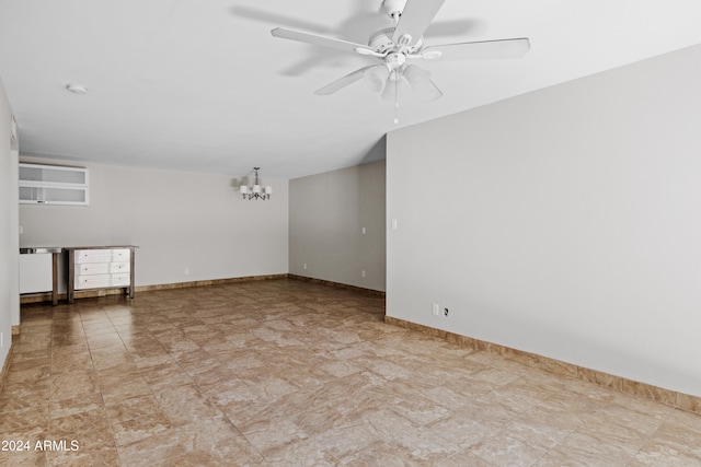 unfurnished room featuring ceiling fan with notable chandelier