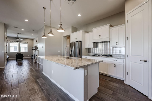kitchen with visible vents, decorative backsplash, appliances with stainless steel finishes, and white cabinets