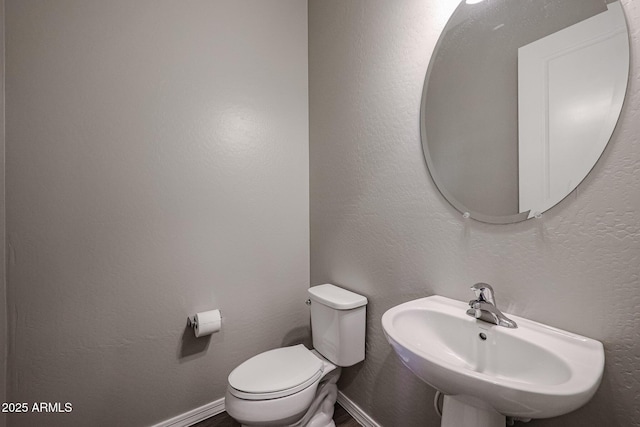 bathroom featuring a sink and toilet