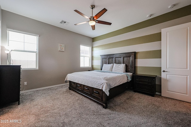 carpeted bedroom featuring baseboards, visible vents, and ceiling fan