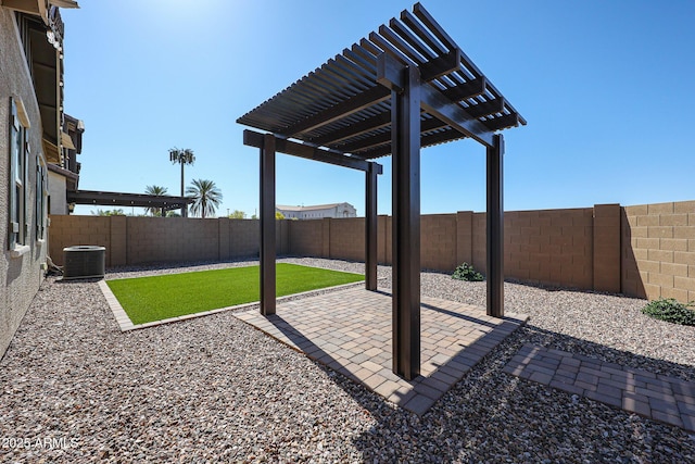 view of yard with a patio, central AC unit, a fenced backyard, and a pergola