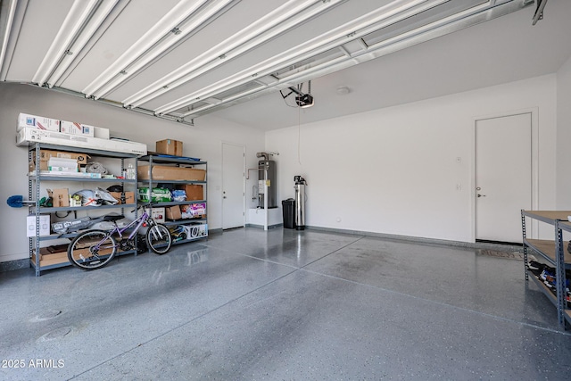garage featuring a garage door opener and electric water heater