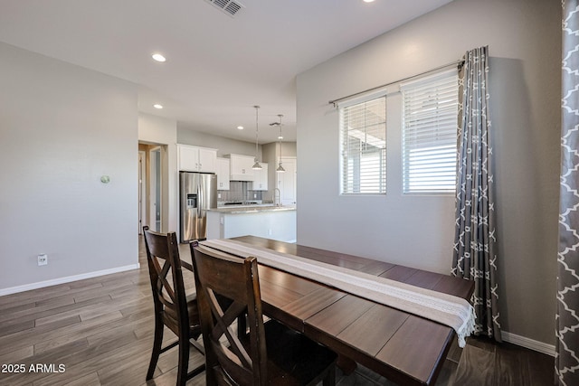 dining space with recessed lighting, dark wood-style flooring, baseboards, and visible vents