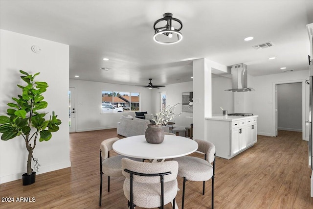 dining space featuring ceiling fan and light wood-type flooring