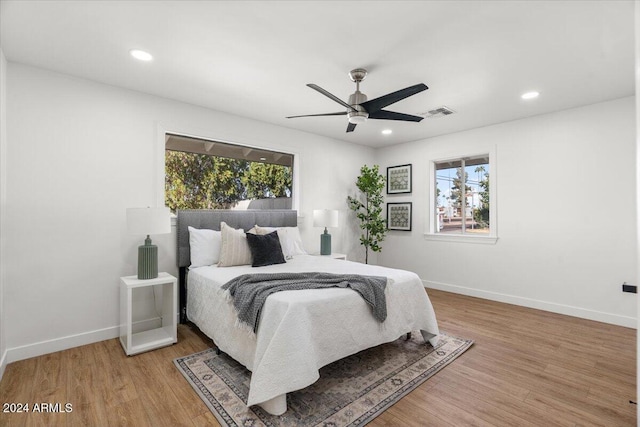 bedroom with hardwood / wood-style floors and ceiling fan