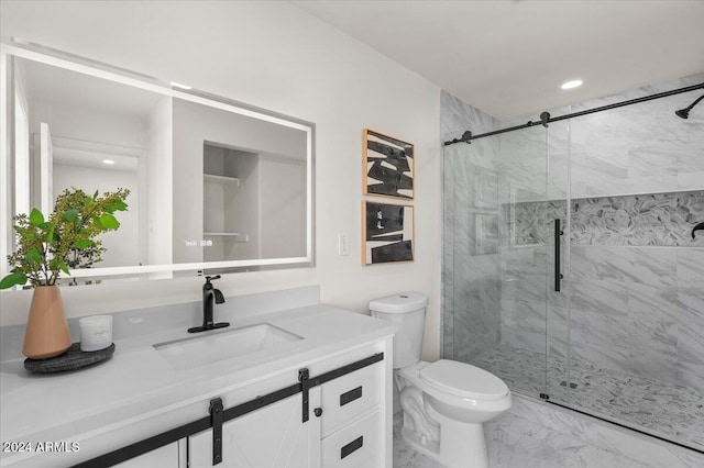 bathroom featuring an enclosed shower, vanity, and toilet