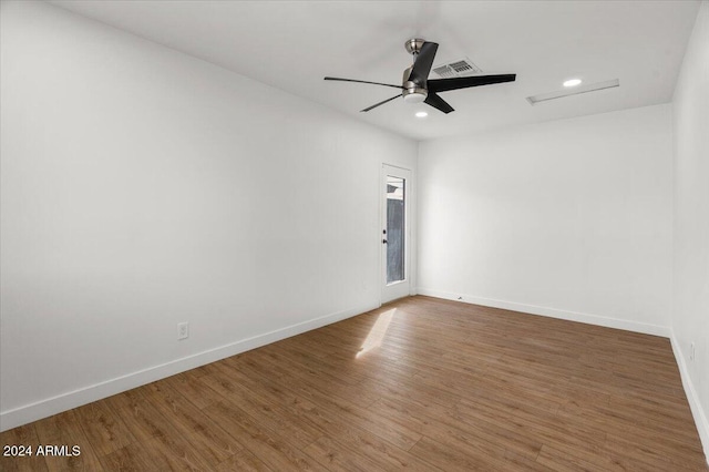 spare room with hardwood / wood-style floors and ceiling fan