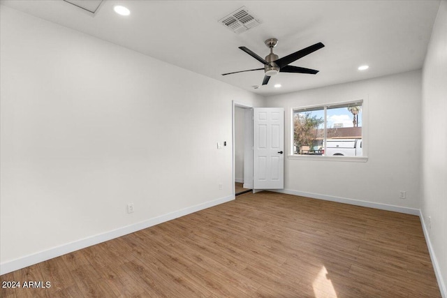 spare room featuring wood-type flooring and ceiling fan