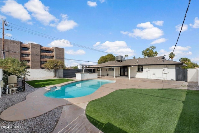 view of pool featuring central air condition unit, a patio area, and a lawn