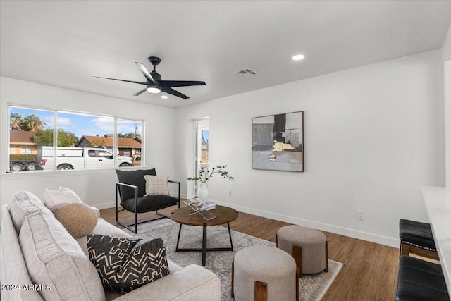 living room with ceiling fan, wood-type flooring, and separate washer and dryer