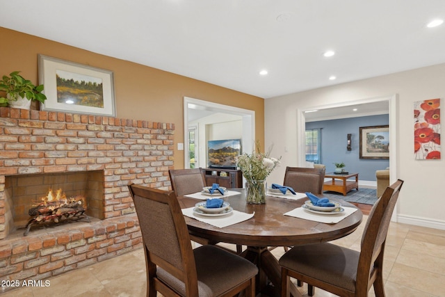 7042 N 13th St, Phoenix, AZ 85020 - dining space featuring light tile patterned floors, baseboards, a brick fireplace, and recessed lighting