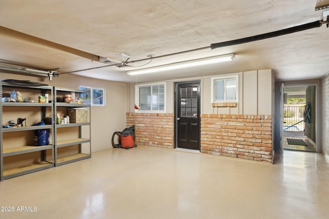 7042 N 13th St, Phoenix, AZ 85020 - interior space featuring brick wall and a garage