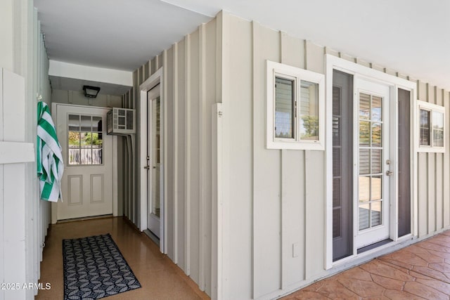 7042 N 13th St, Phoenix, AZ 85020 - property entrance featuring an AC wall unit and board and batten siding