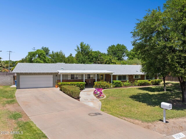 7042 N 13th St, Phoenix, AZ 85020 - single story home with fence, an attached garage, a front lawn, a porch, and concrete driveway