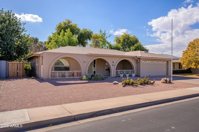 single story home featuring a garage and a porch