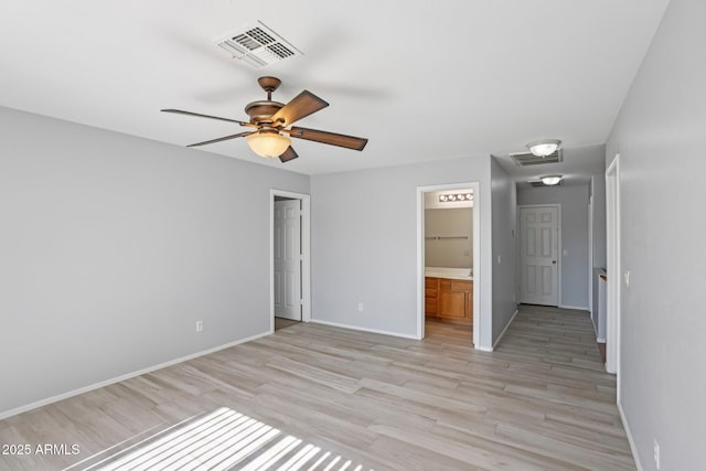 9420 S 35th Gln, Laveen, AZ 85339 - unfurnished bedroom with light wood finished floors, baseboards, connected bathroom, and attic access
