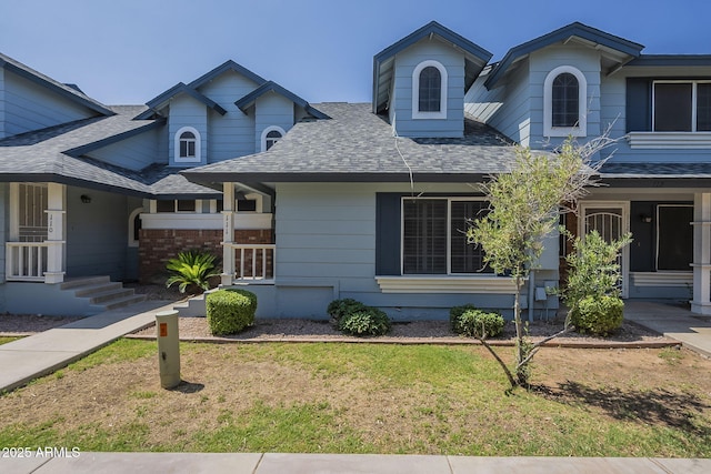10101 N 91st Ave Unit 111, Peoria, AZ 85345 - view of front facade featuring a shingled roof and a front yard