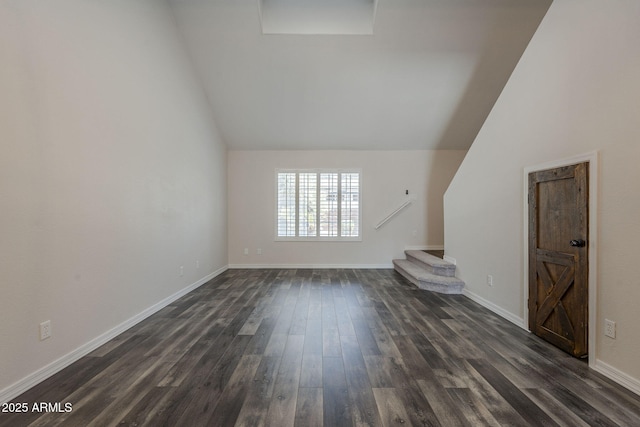 10101 N 91st Ave Unit 111, Peoria, AZ 85345 - unfurnished living room with dark wood-type flooring, lofted ceiling, stairway, and baseboards