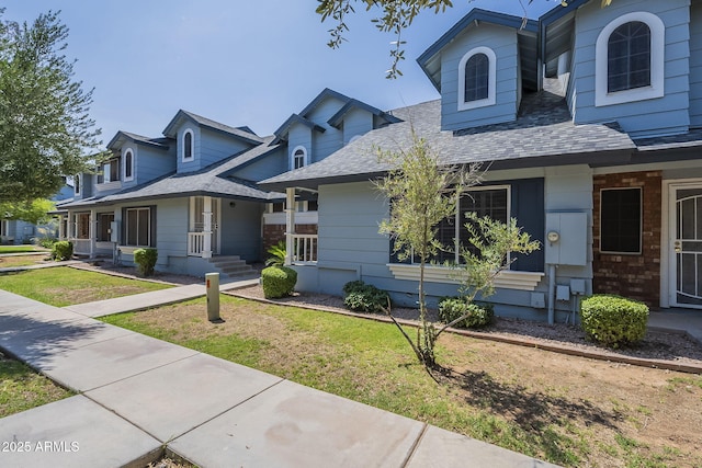 10101 N 91st Ave Unit 111, Peoria, AZ 85345 - view of front of home featuring a shingled roof and a front lawn