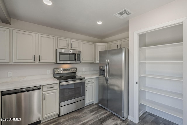 10101 N 91st Ave Unit 111, Peoria, AZ 85345 - kitchen with stainless steel appliances, dark wood-type flooring, recessed lighting, and light stone counters