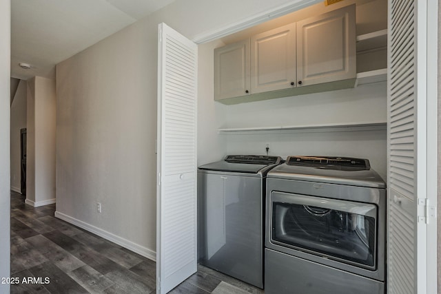 10101 N 91st Ave Unit 111, Peoria, AZ 85345 - laundry area featuring cabinet space, washer and clothes dryer, dark wood-style floors, and baseboards