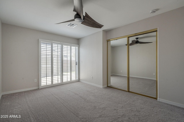 10101 N 91st Ave Unit 111, Peoria, AZ 85345 - unfurnished bedroom featuring carpet floors, a closet, a ceiling fan, and baseboards