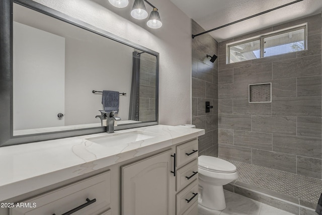 10101 N 91st Ave Unit 111, Peoria, AZ 85345 - full bathroom with vanity, toilet, a tile shower, and a textured wall