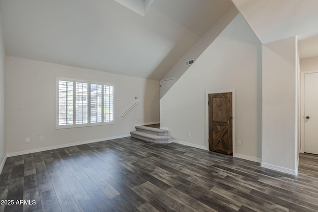 10101 N 91st Ave Unit 111, Peoria, AZ 85345 - unfurnished living room with dark wood-style flooring, baseboards, stairs, and high vaulted ceiling