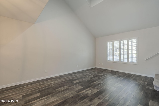 10101 N 91st Ave Unit 111, Peoria, AZ 85345 - unfurnished living room with vaulted ceiling, dark wood-style floors, and baseboards