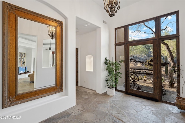 36600 N 50th St, Cave Creek, AZ 85331 - entryway with stone floors, a chandelier, ceiling fan, and a towering ceiling