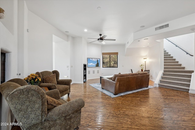 living room with ceiling fan and dark hardwood / wood-style flooring