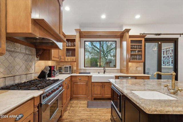 36600 N 50th St, Cave Creek, AZ 85331 - kitchen featuring appliances with stainless steel finishes, a sink, premium range hood, light stone counters, and recessed lighting