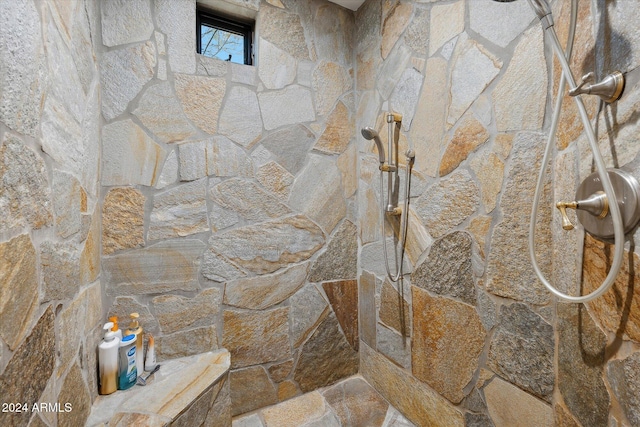 interior details featuring tiled shower