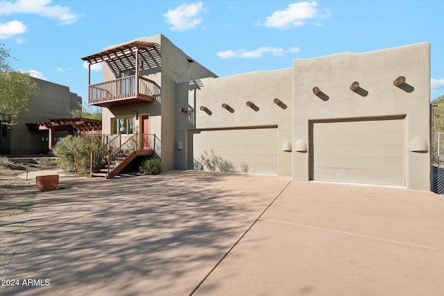 view of front of home featuring a balcony and a garage