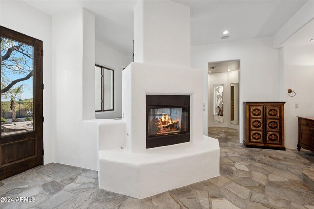 36600 N 50th St, Cave Creek, AZ 85331 - foyer with stone finish floors, a multi sided fireplace, and recessed lighting