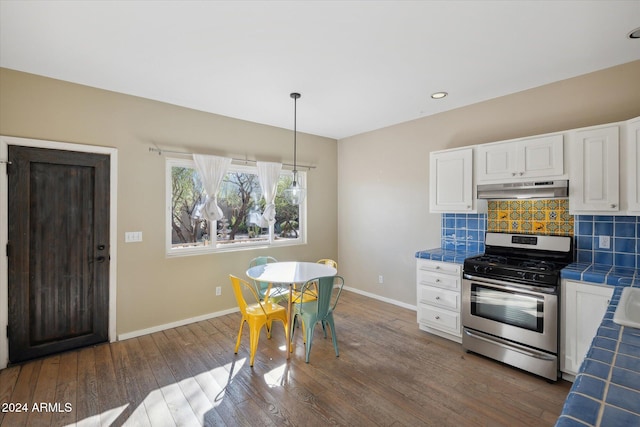 kitchen with tile countertops, stainless steel gas stove, dark hardwood / wood-style floors, and white cabinetry