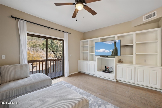 living room with ceiling fan and light wood-type flooring