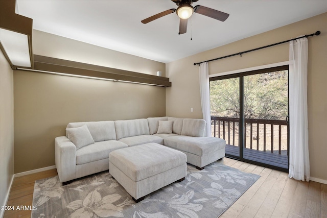 living room with ceiling fan and light wood-type flooring