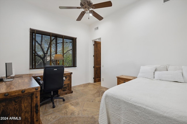 36600 N 50th St, Cave Creek, AZ 85331 - bedroom with light stone finish flooring, an office area, and a ceiling fan