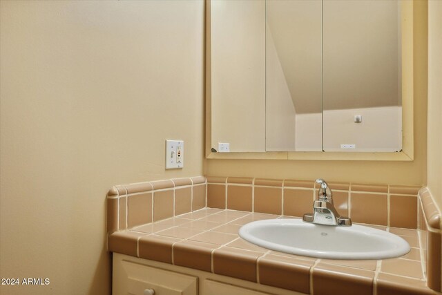 bathroom with decorative backsplash and vanity